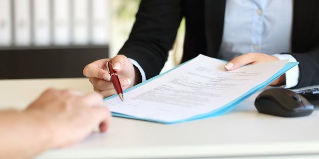 Executive hands indicating where to sign contract